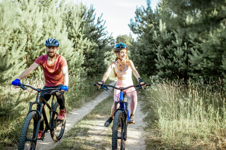 Couple riding mountain bikes