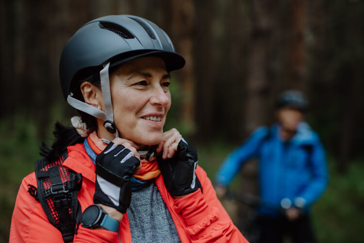 senior wearing helmet while cycling