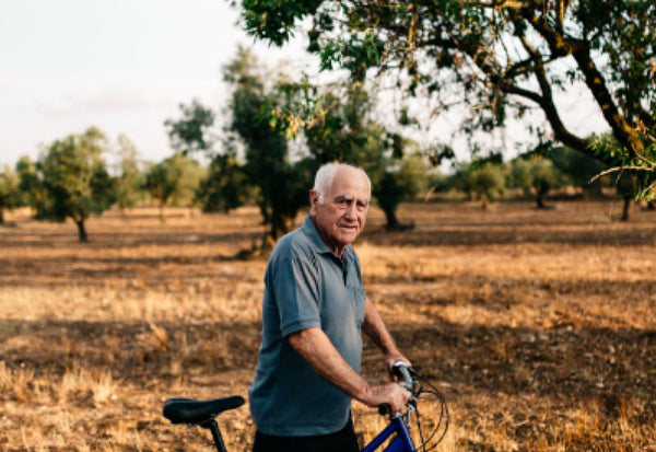 elderly man walking tricycle