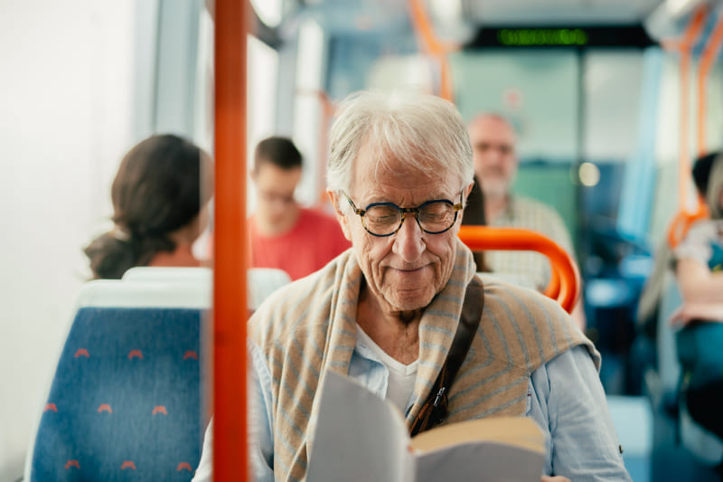 Elderly man riding the bus