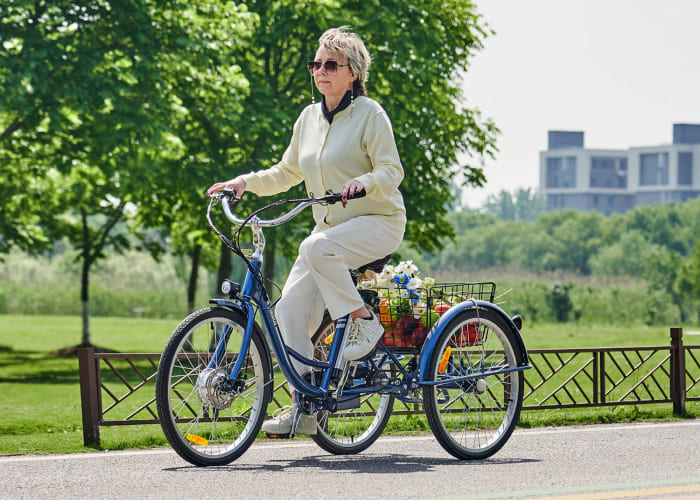 Elderly lady riding a tricycle