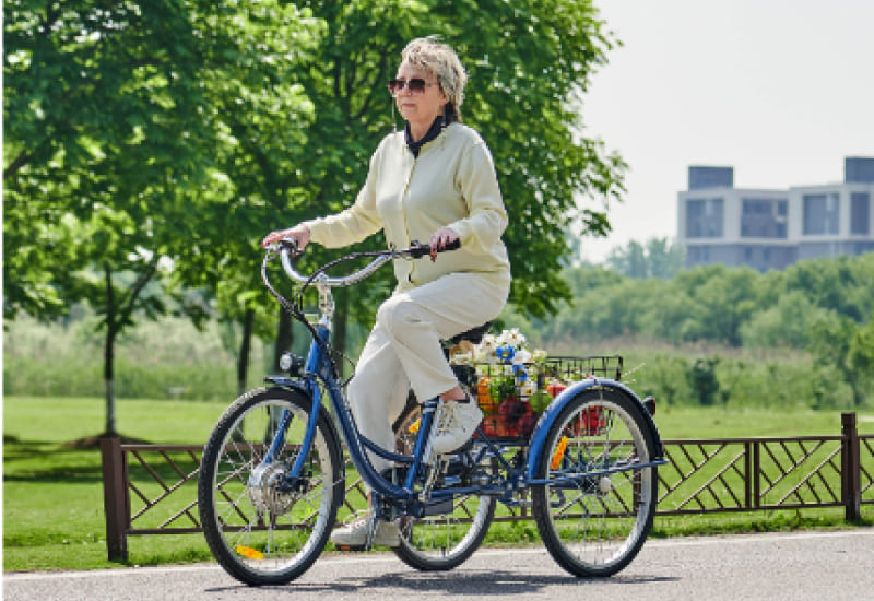 senior citizen riding electric tricycle