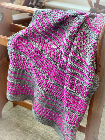 pink and gray knitted blanket