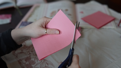 Piper and Leaf crafter rounding cut paper edges for a DIY galentine valentine craft