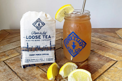 A muslin bag of Front Porch Special, a jar of tea & lemonade, and slices of lemon