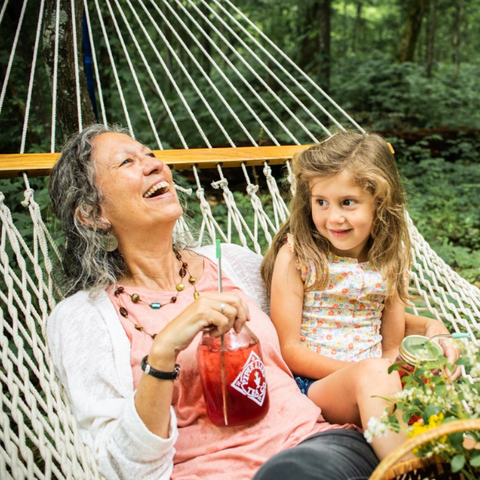 Grandma and Grandkid hanging out on a hammock with Strawberry shindig