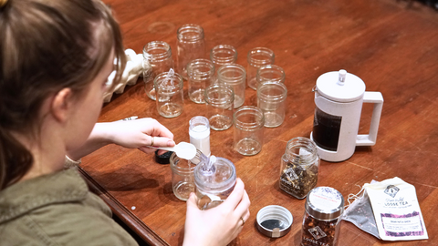 Adding vinegar to a jar with an easy pour spout for a fun, easy DIY Tea Dye Easter Eggs