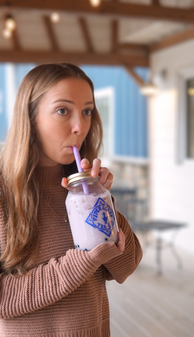 a girl dinking a jar of Piper and Leaf iced bubble tea