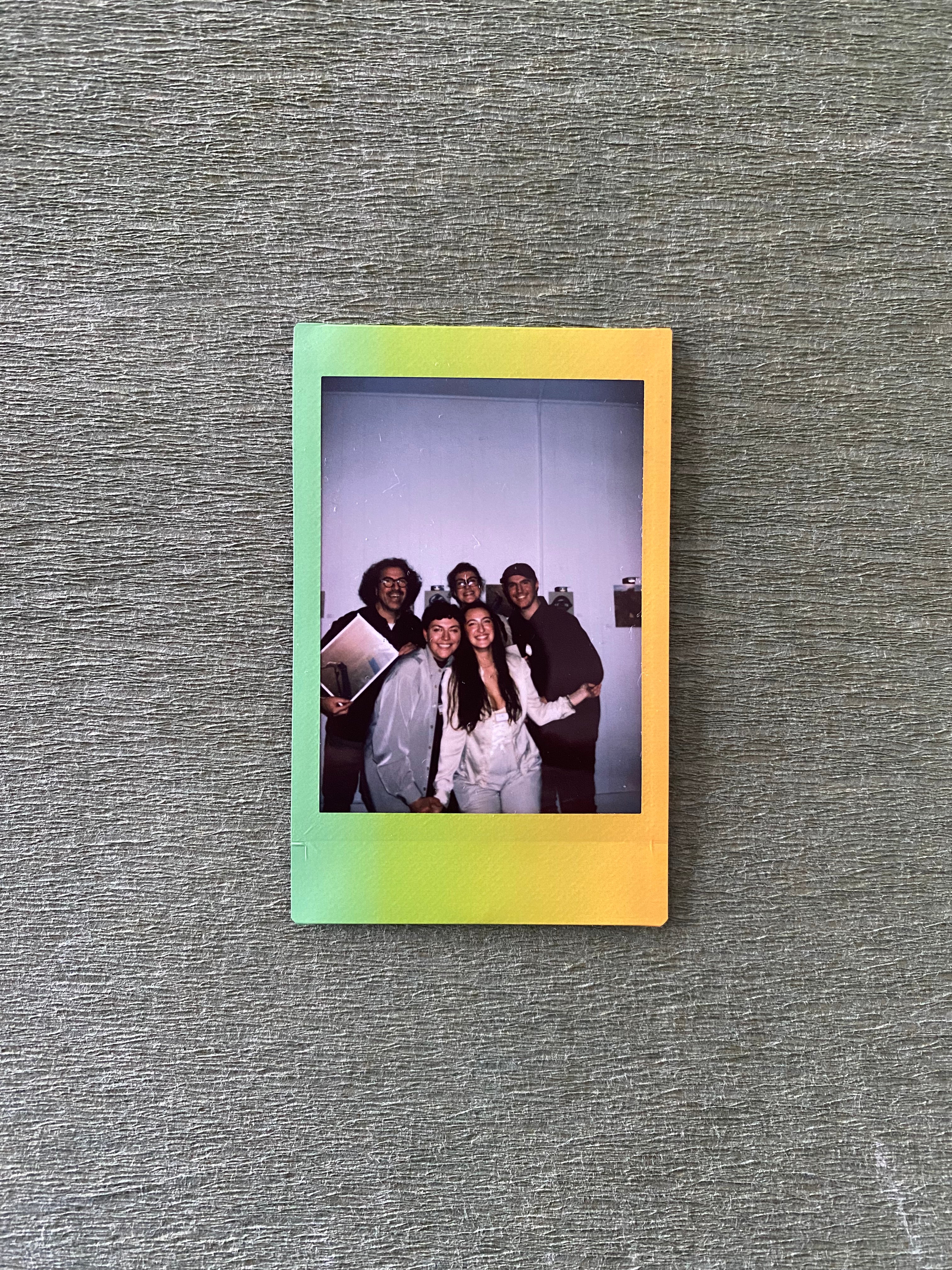 A polaroid photo features Bertie and their family: mom, dad, brother, and sister