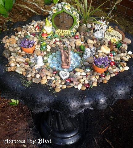 Fountain filled with rocks and trinkets to create the perfect fairy garden