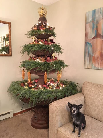 Fountain decorated with garland and ornaments to resemble a Christmas tree