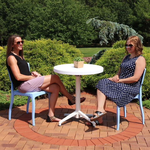 two friends enjoying a sunny day on their resin patio furniture