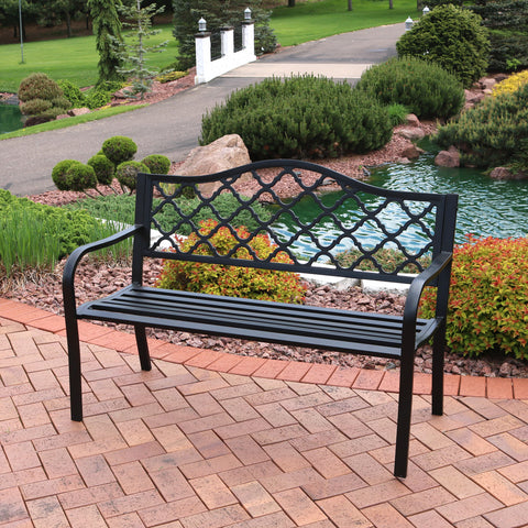 cast iron patio bench on backyard pavers