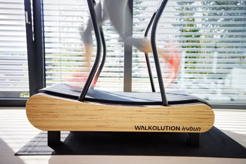 a woman running on a treadmill desk