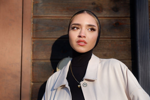 girl in hijab bodysuit with necklace