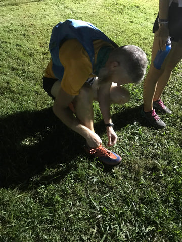 Runner lacing up at the start of an ultramarathon