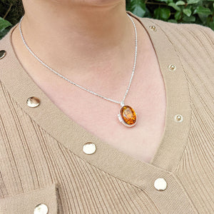 silver amber locket  necklace being worn