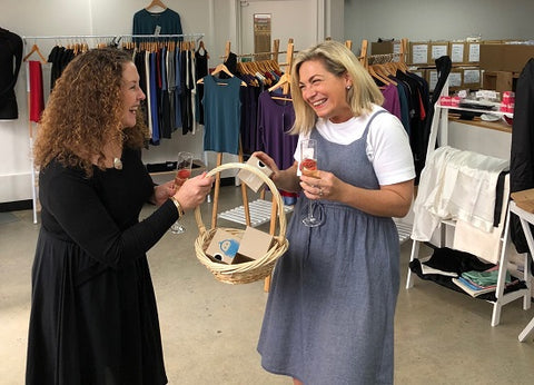 Laurian holds the prize basket while Lucy chooses a spot prize