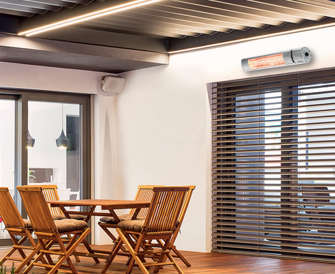 A patio area with wooden furniture and a KM-20 2KW Infrared Outdoor Wall Mounted Garden Heated attached above.