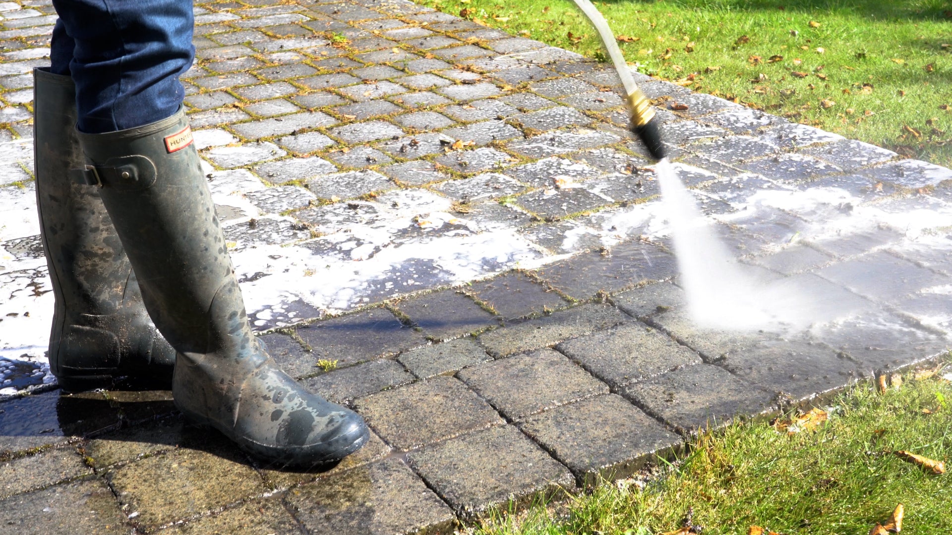 Close up of man using turbo nozzle to increase accuracy of water steam on pressure washer