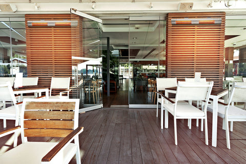 The interior of a cafe with a selection of KMH-30 3KW Infrared Wall Mounted Outdoor Garden Heaters displayed inside