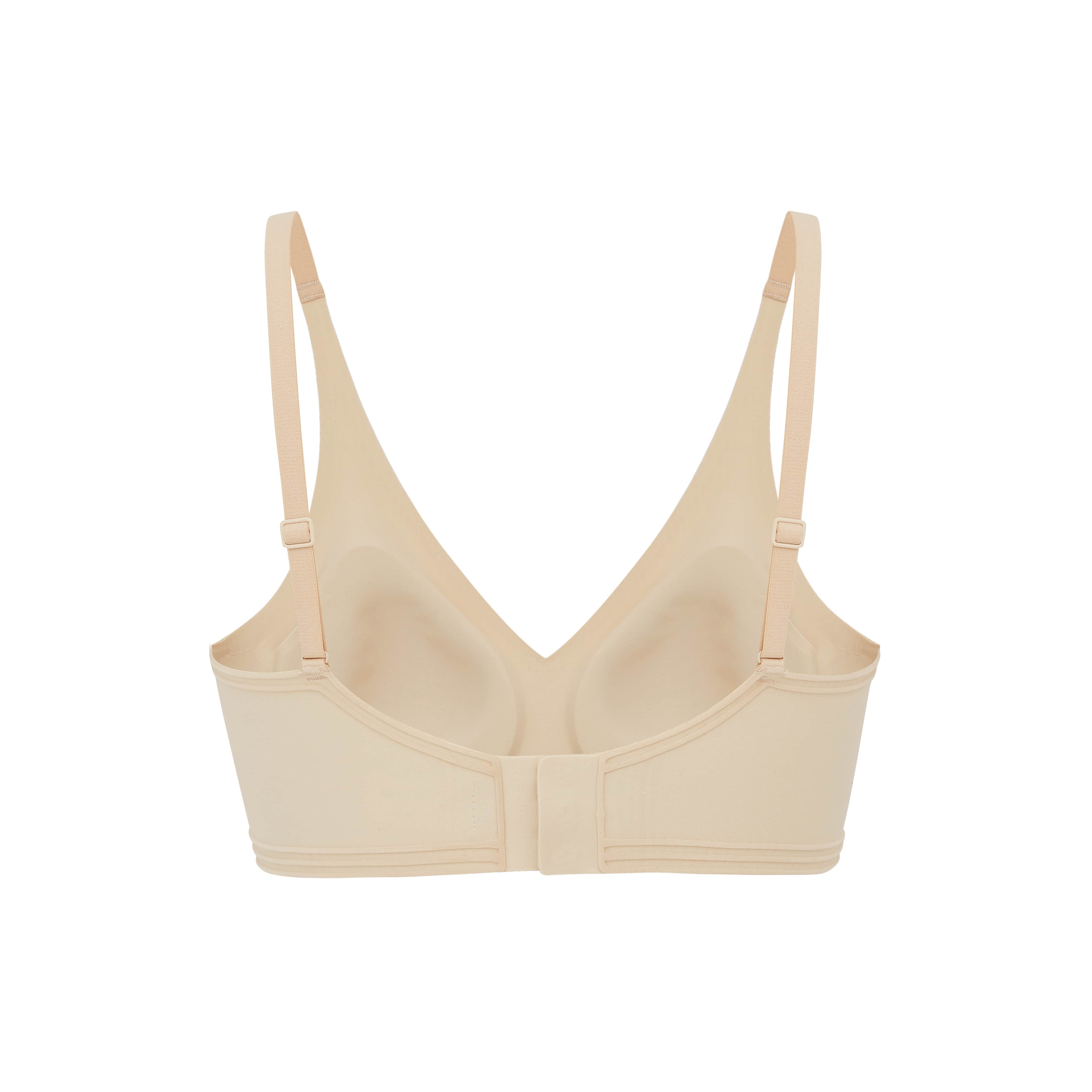 Interior flat lay image of beige bra with plunge neckline and back clasp
