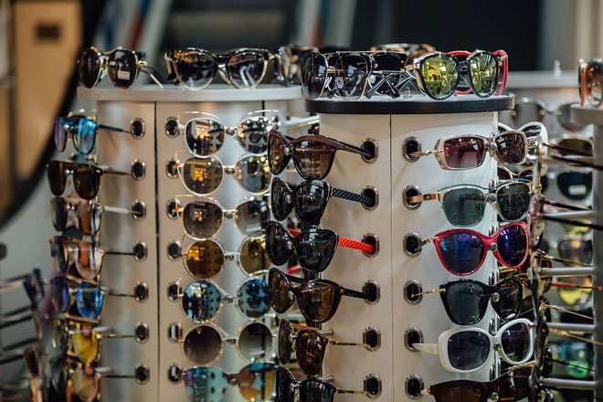 Different fashion multicolored sunglasses on the store counter