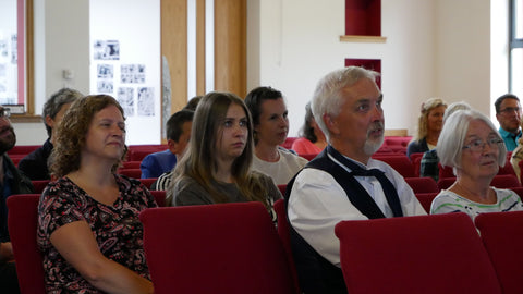 People sitting in a hall listening to a speech