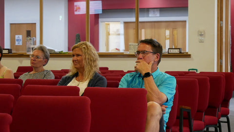 People in an audience listening to a talk