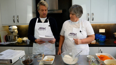 Man and woman looking at a recipe book