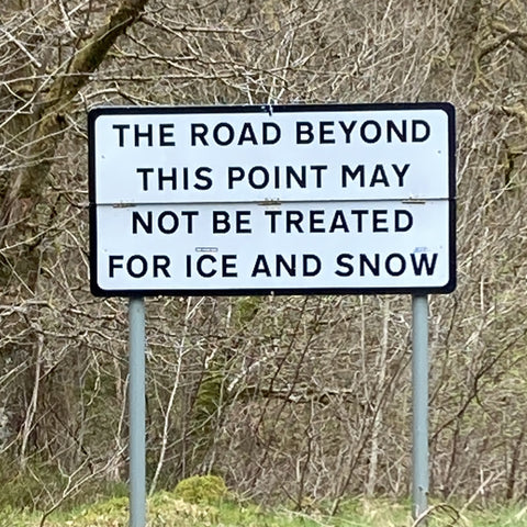 Warning sign saying the road beyond this point may not be treated for ice and snow