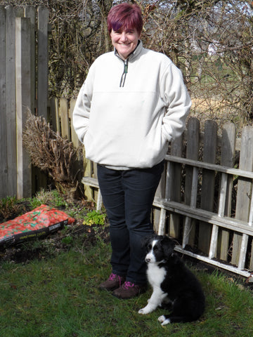 Lady standing next to a black and white Border Collie puppie