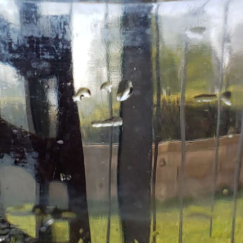 smiley face on the edge of a drinking glass