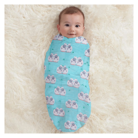 baby using blue sheep printed polka tots muslin swaddle organic cotton.