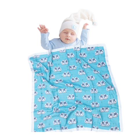 baby wearing blue sheep organic cotton muslin blanket