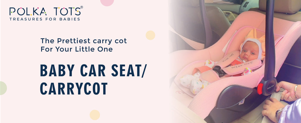 baby sleeping in the infant pink color car seat