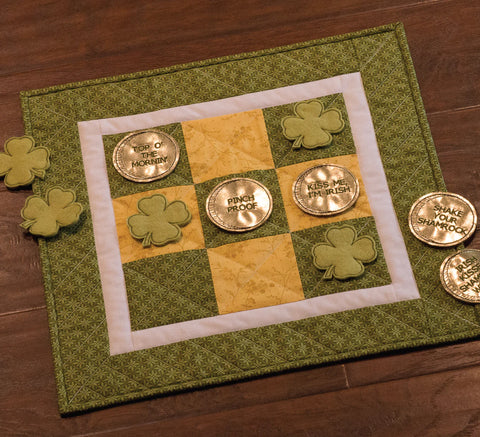 shamrock and gold pieces on tic tac toe board