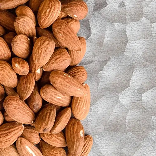 Close up of whole almonds on a tray.