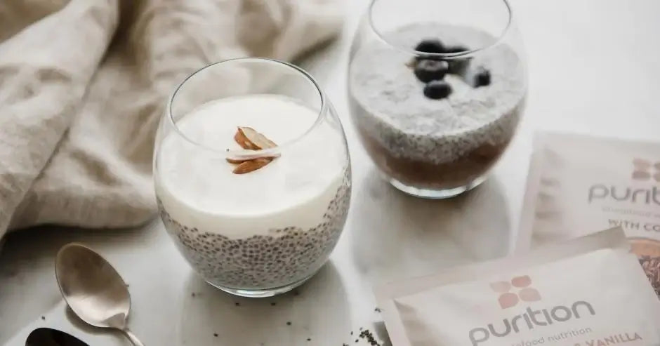 Purition chia seed puddings, one topped with almonds, the other with blueberries.