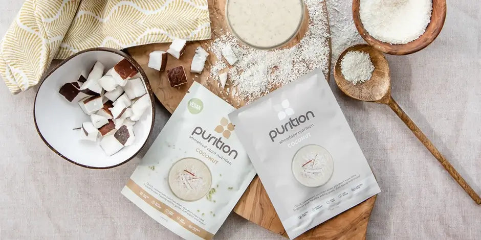 Lifestyle photograph of Purition Coconut sachets, including fresh coconut pieces in a coconut bowl.