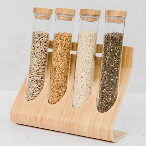 Test tubes in wooden stand filled with sunflower kernels, flax, sesame seeds and chia seeds