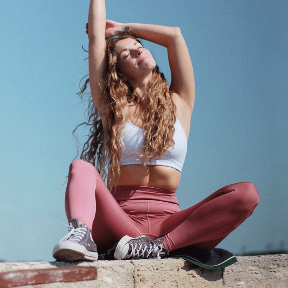 Photograph of Daisy Tonge yoga teacher in relaxed stretch.