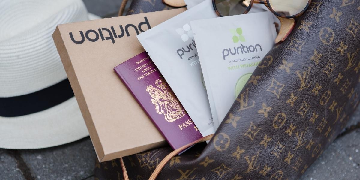 Hand luggage containing a selection of Purition sample packs - easy to take on the go.