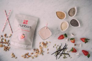 A 500g bga of Purition surrounded by whole food ingredients for nutrition and natural flavour.