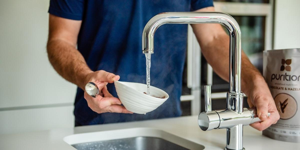 Man pouring water into bowl of Purition instant porridge