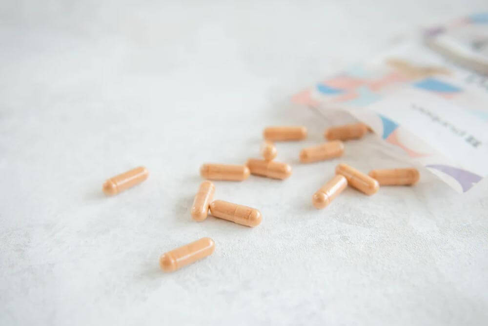 An open packet of Purition's multi nutrient with some capsules spilled out onto work surface