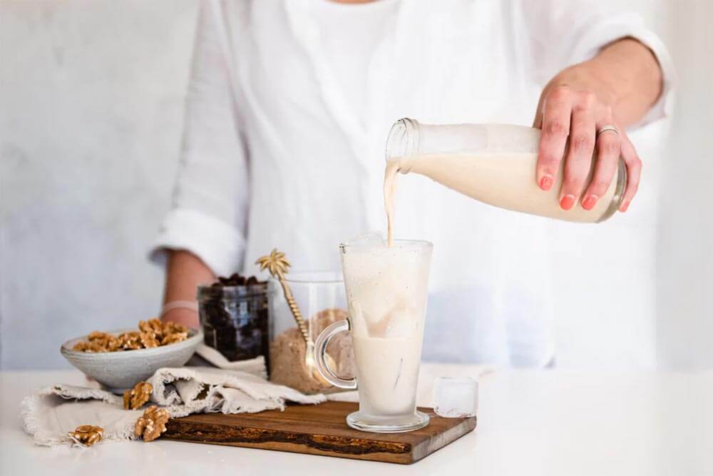 Person holding a warming cup of Purition's Golden Milk Super Latte