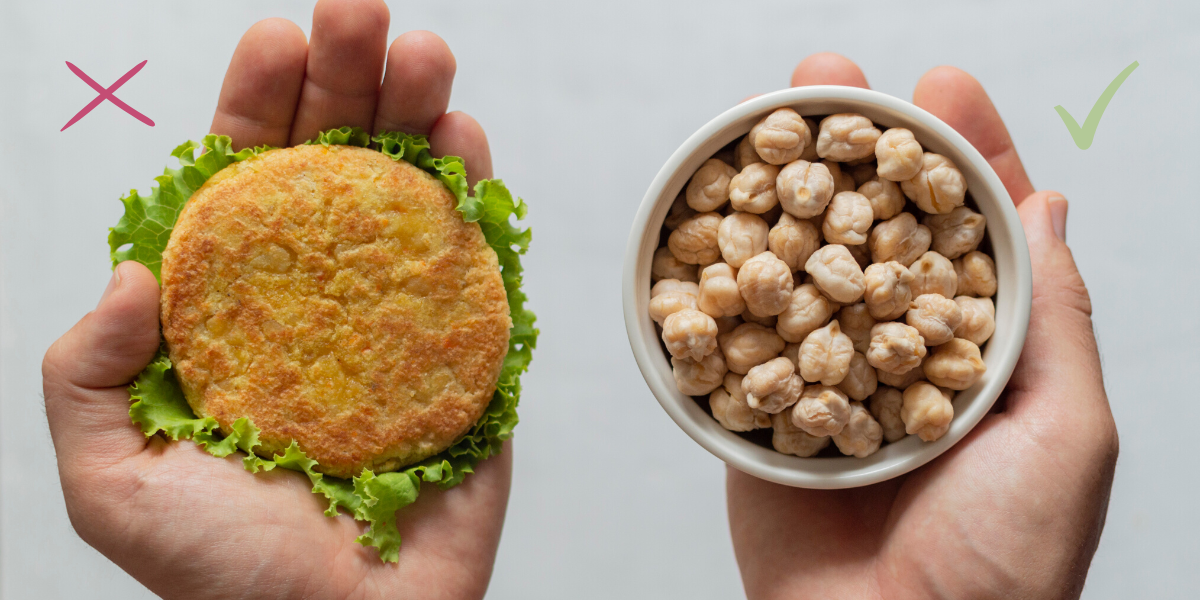Hand holding processed vegan burger vs unprocessed chickpeas