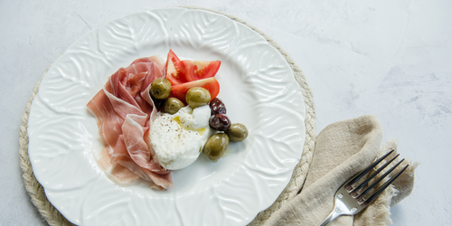 Low-carb snack plate of olives, tomatoes, eggs and ham