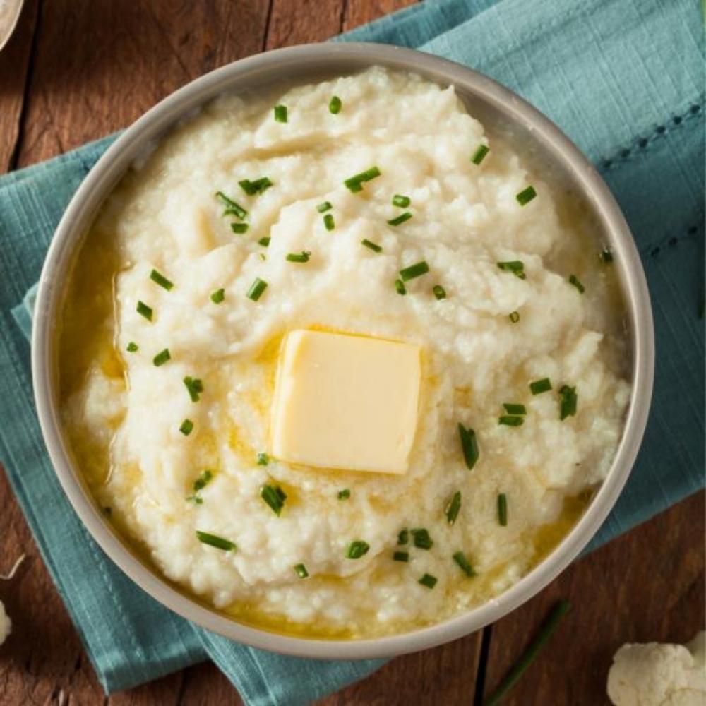 Bowl of cauliflower mash with butter and herbs